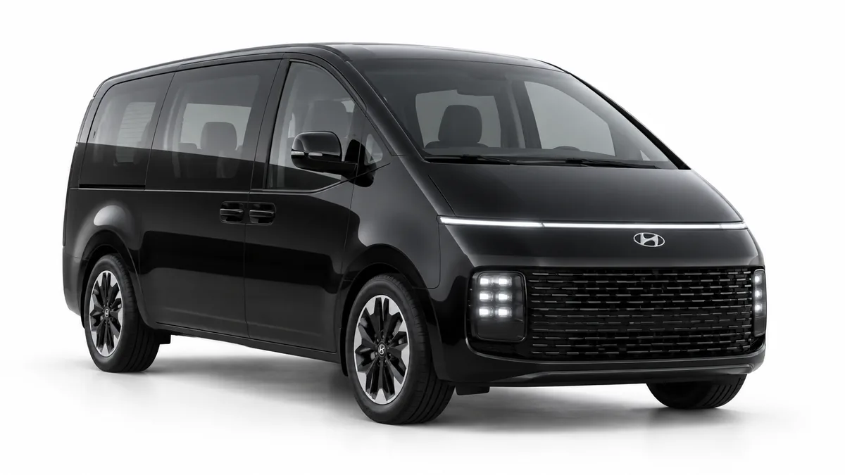 black Hyundai Staria on a white studio background